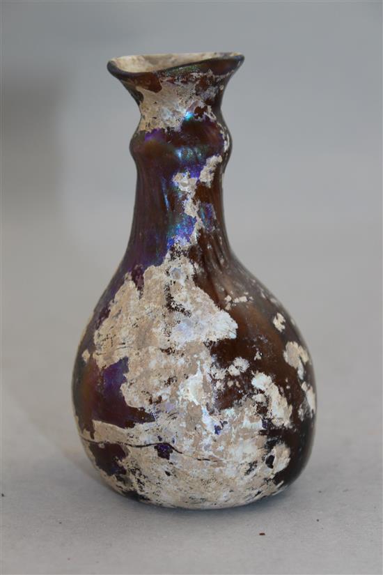 A Roman amber glass flask, c.2nd century AD, 11cm